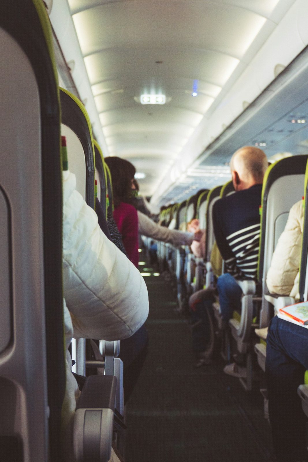 Passengers in an aircraft cabin, photographed at Lisbon Airport.