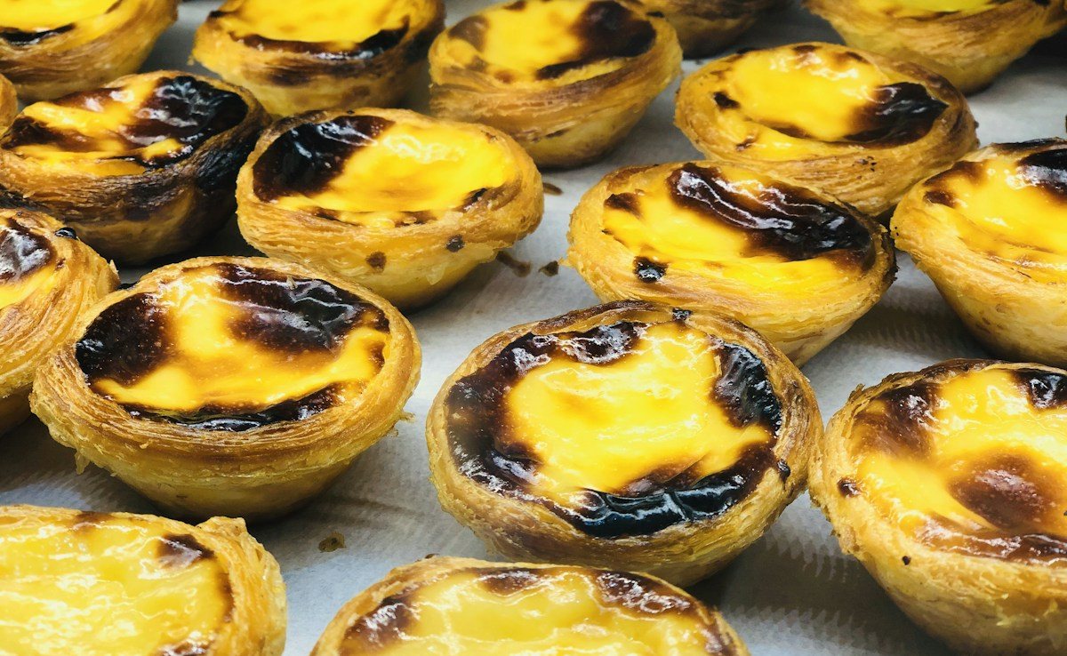 Portuguese custard tarts photographed on Rua Augusta in Lisbon.