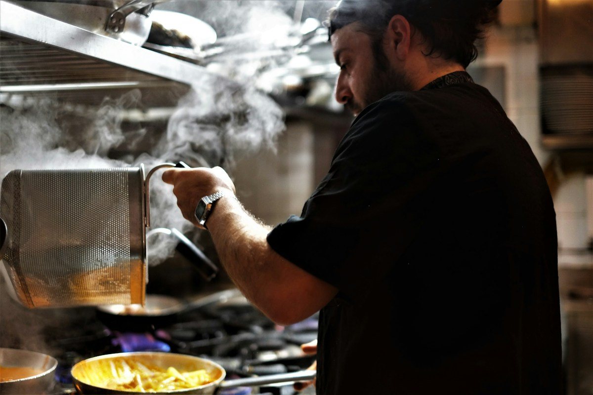 A cook working in a kitchen in Rome.