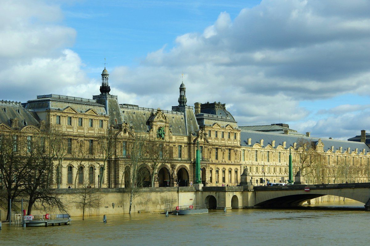 The Louvre buildings seen across the Seine in Paris.